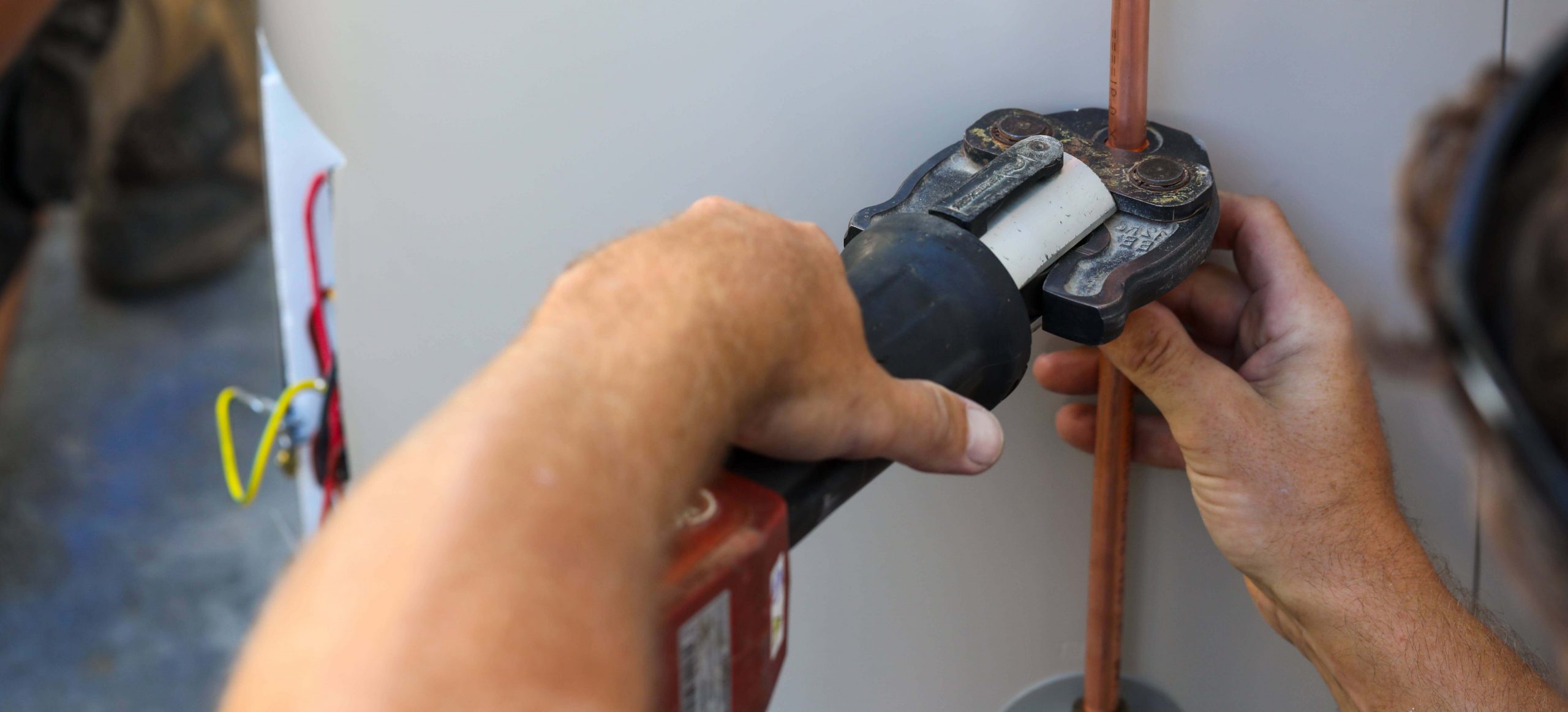 An expert repairing a faulty immersion heater