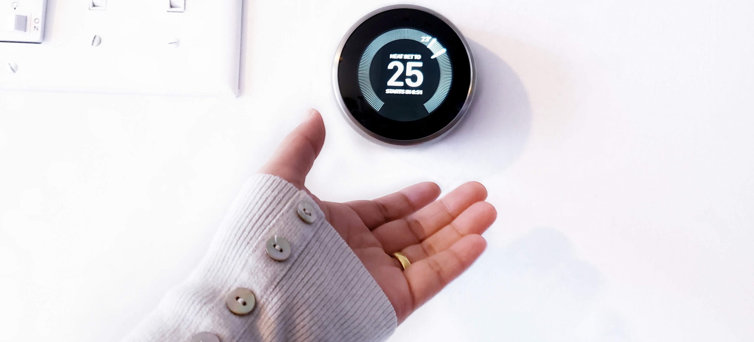 A woman choosing a smart heating thermostat